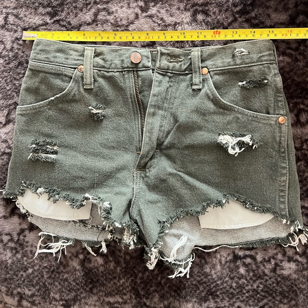 Sage green distressed Wrangler shorts